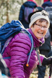 Woman hiking and smiling at the camera