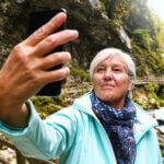 Mature woman taking a selfie outdoors on an autumn day