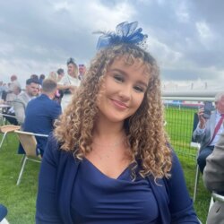 Woman in blue wearing a fascinator