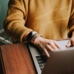 Person typing on a laptop computer at a desk